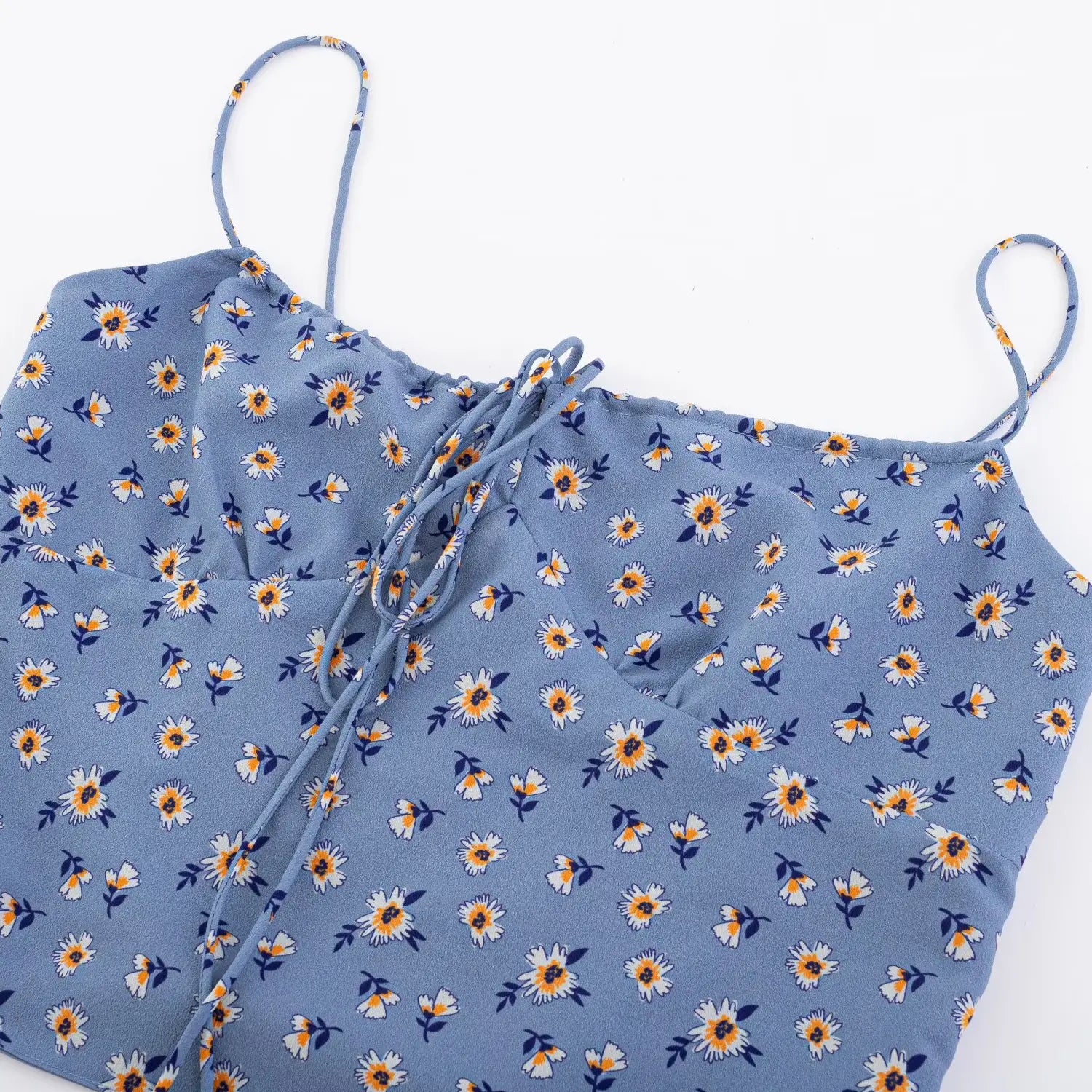 Haze blue daisy floral drawstring cami full front flat lay, elastic neck front tie smocked back waist fitted cropped silhouette white background shot
