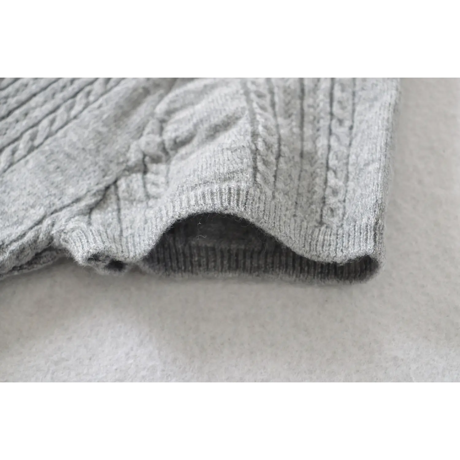Short sleeve cuff ribbed trim close up, vertical hollow cable knit stretch lightweight knitwear