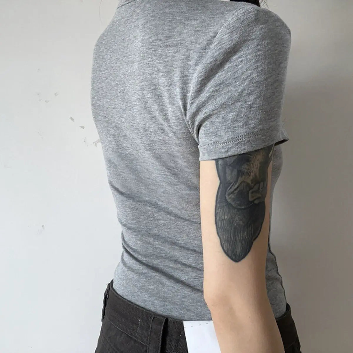 Back view detail shot of heather gray ribbed crew-neck t-shirt, showing fit and fabric