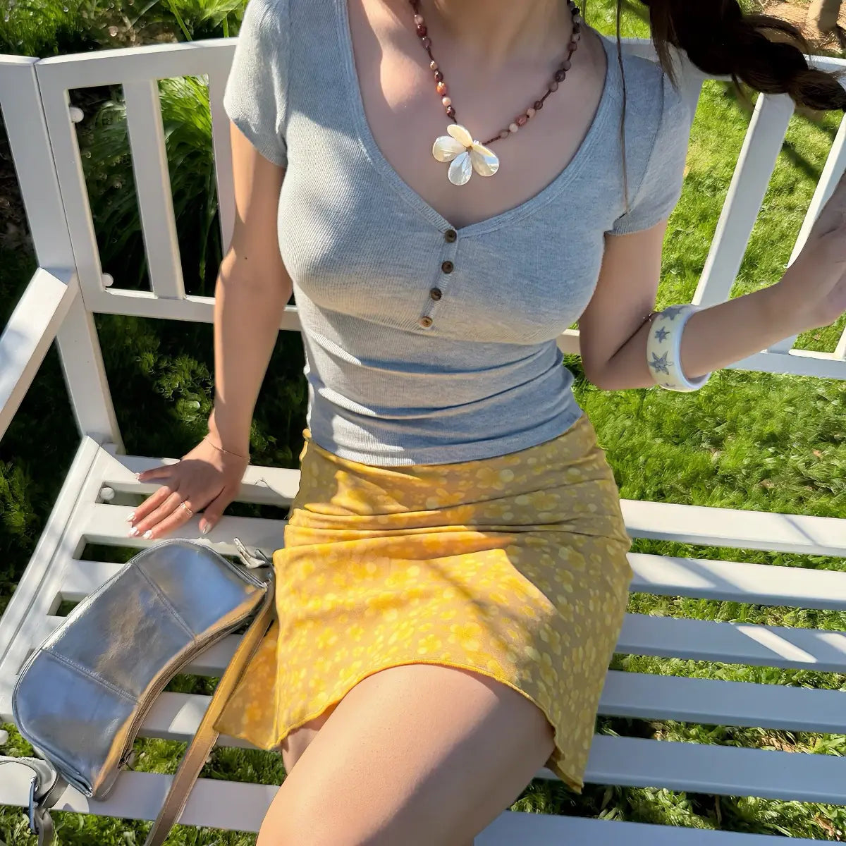  Full body garden bench lifestyle heather gray slim rib knit v-neck top with yellow floral midi skirt