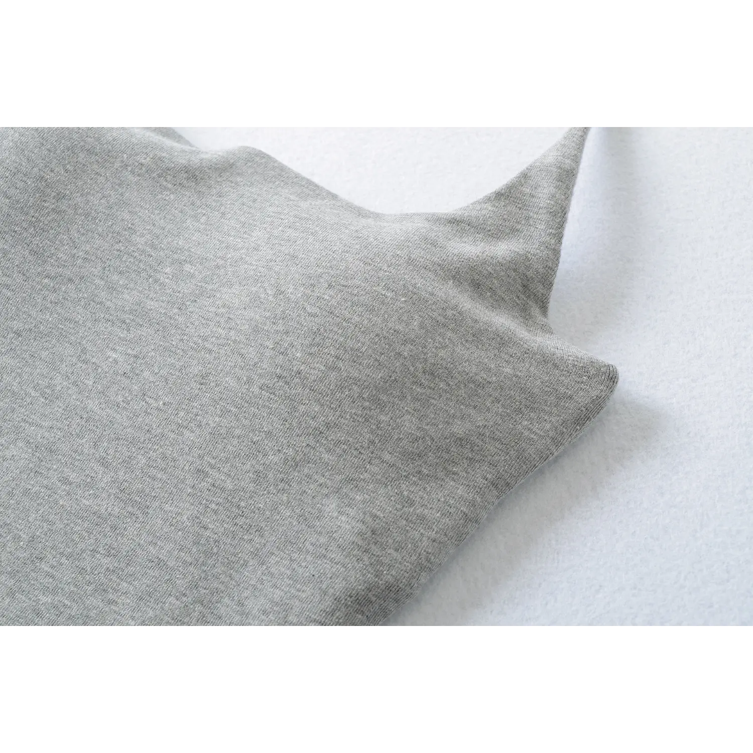 Heather gray stretch knit fabric macro flat close-up, soft brushed knit texture skin-friendly high elasticity solid base fabric white background craft shot