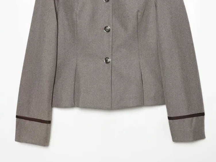Close-up of cropped hem and contrast trim cuffs