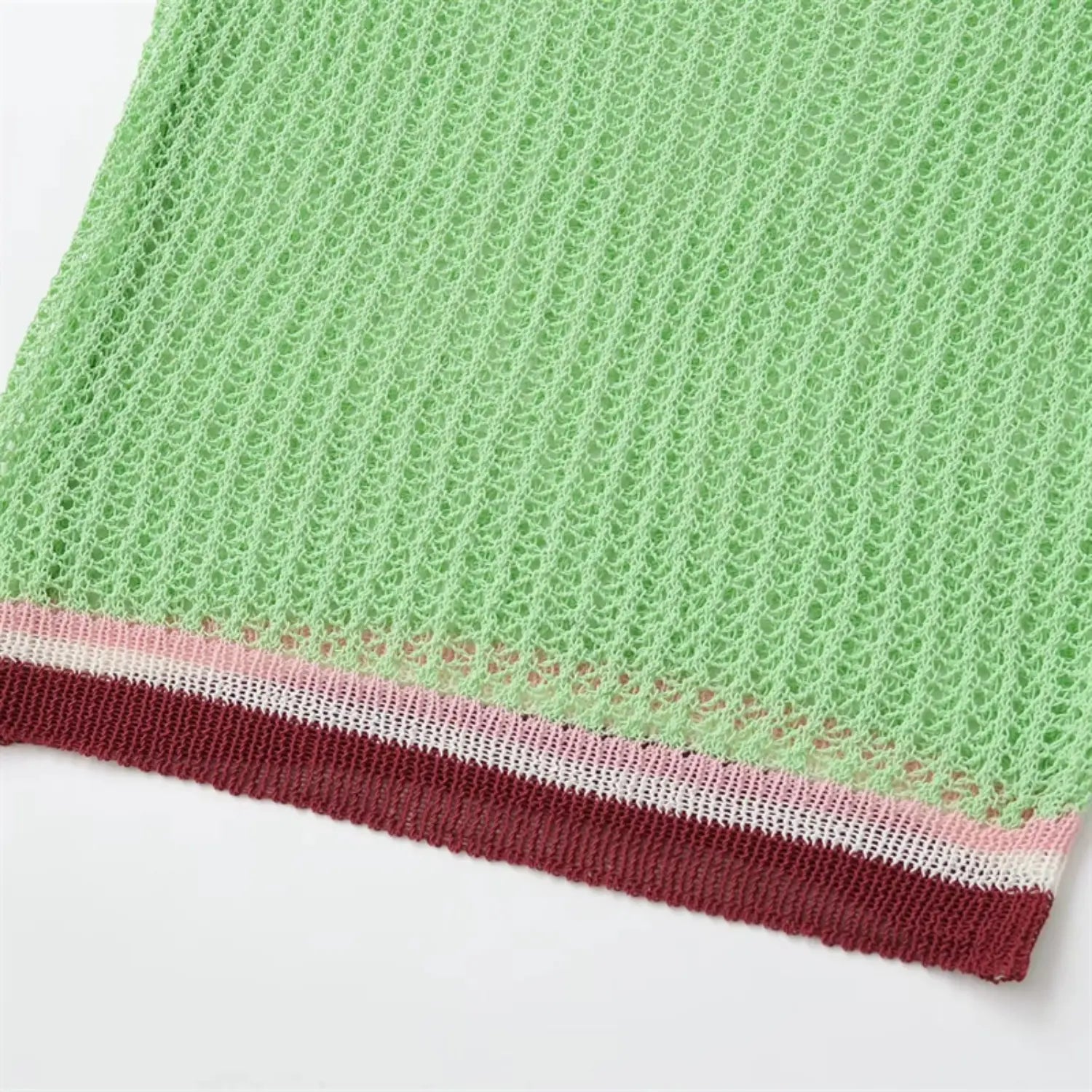 Bottom hem partial view, matching color-block ribbed hem, openwork knit body above, straight relaxed fit