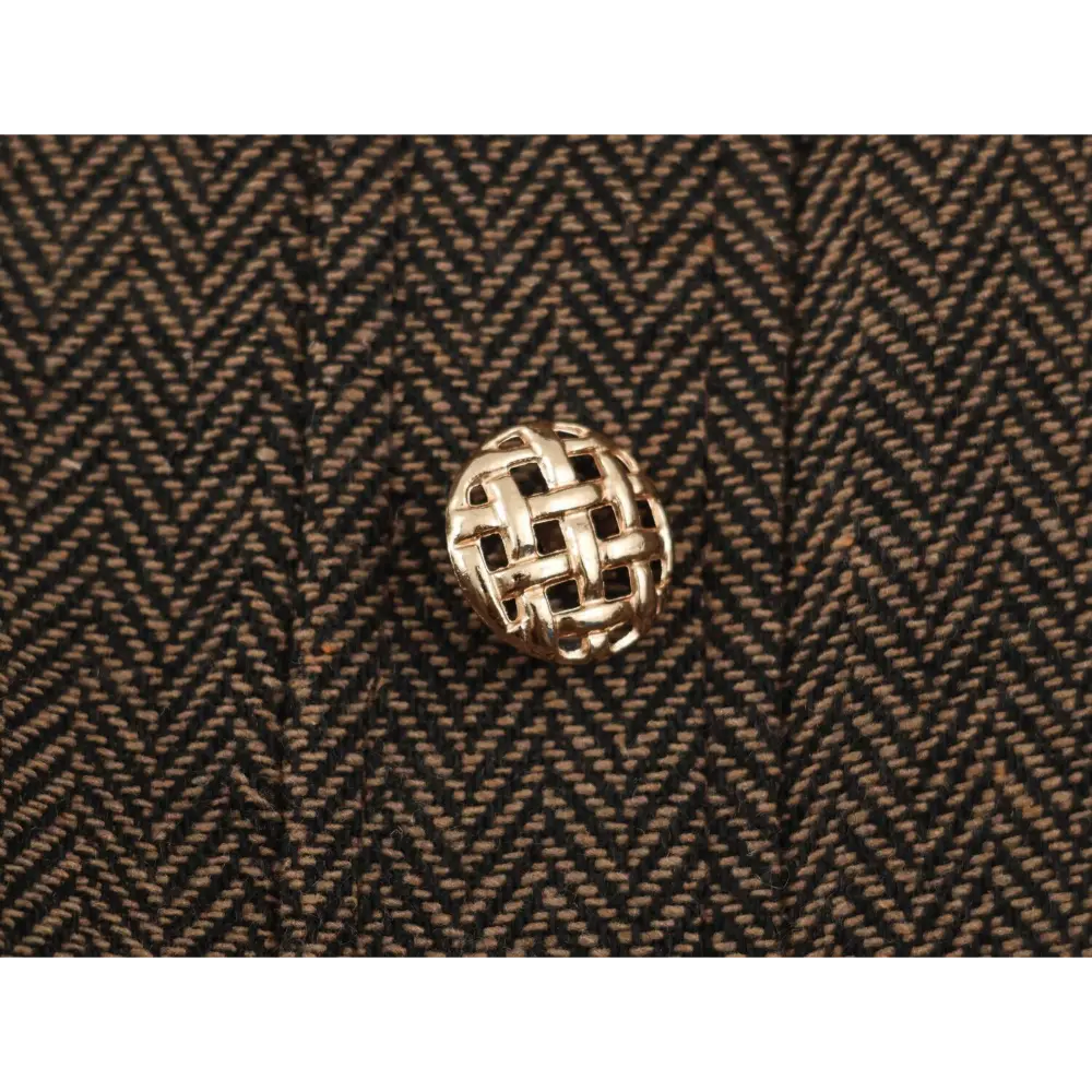 Close-up of gold woven basket button