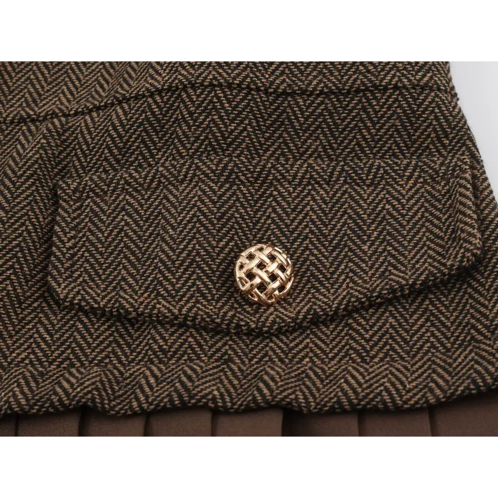 Close-up of flap pocket and gold button detail