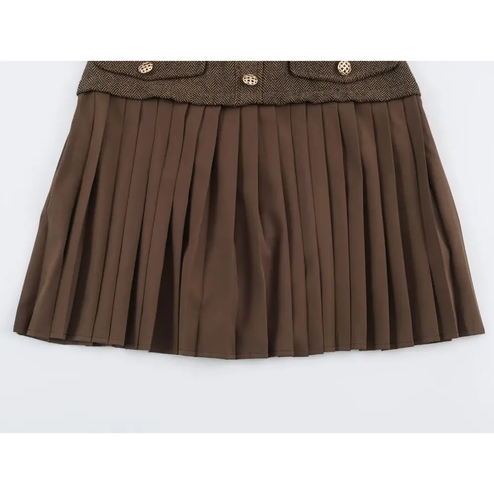 Close-up of flap pockets and pleated skirt