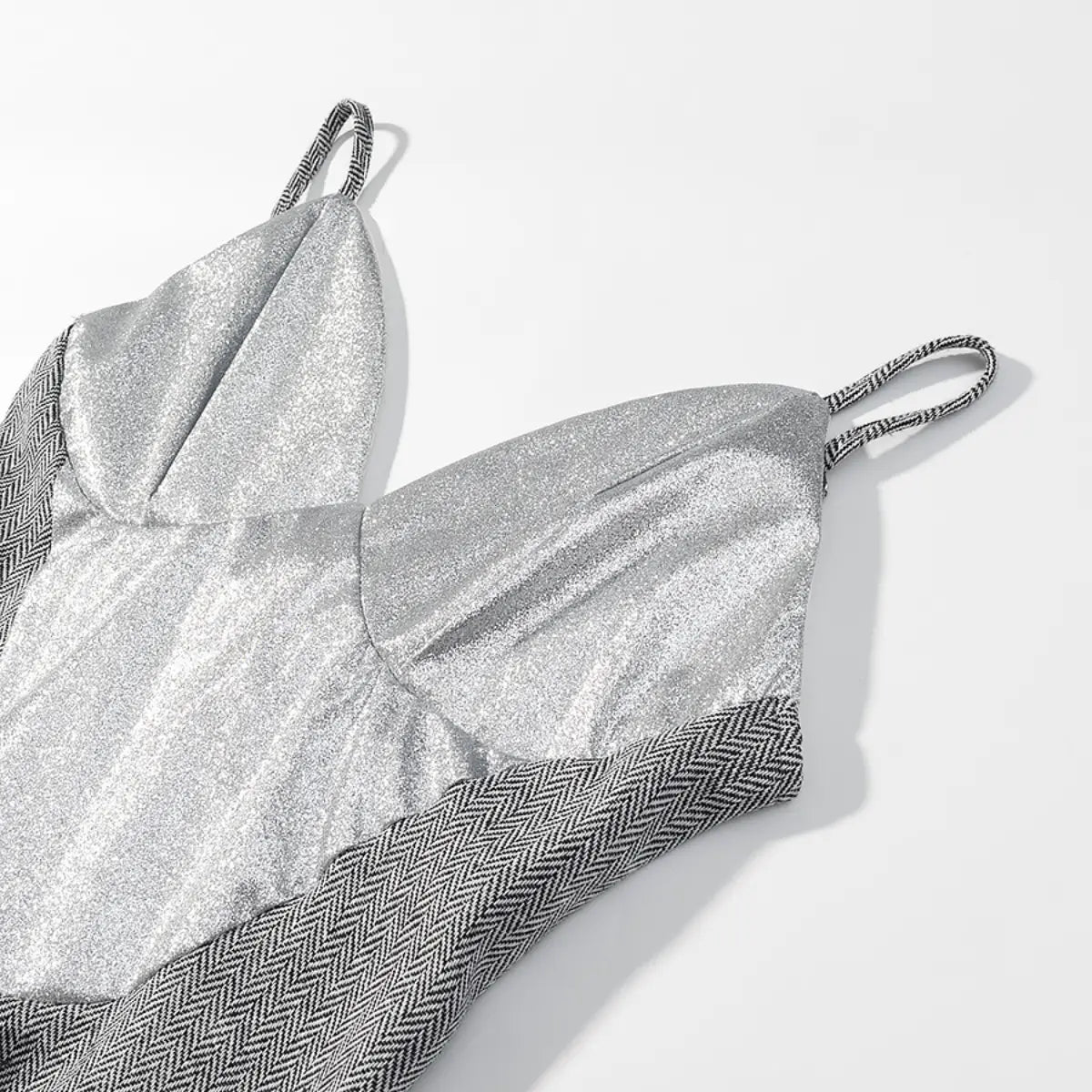 Full view of the herringbone cami top, showing the front lace-up design with white ribbon, silver eyelets, and woven straps