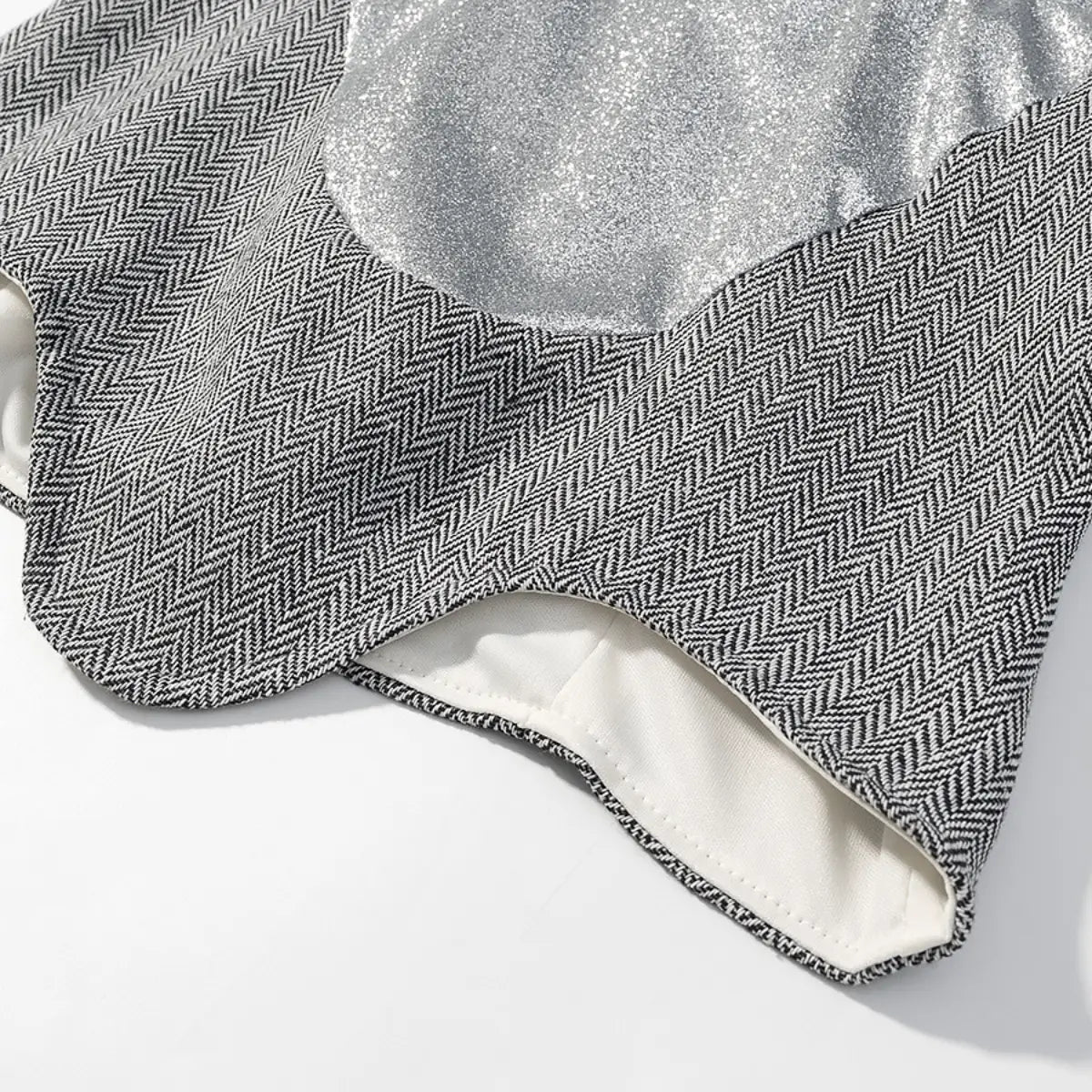 Close-up of the silver glitter fabric on the cami top, showing the sparkly texture and V-shaped bust cups
