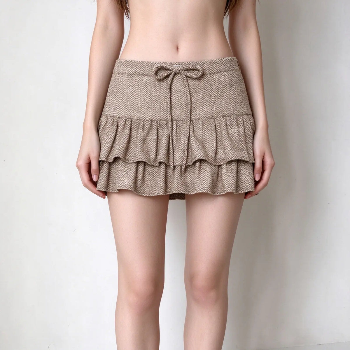 Model wearing herringbone ruffle tiered mini skirt, front view