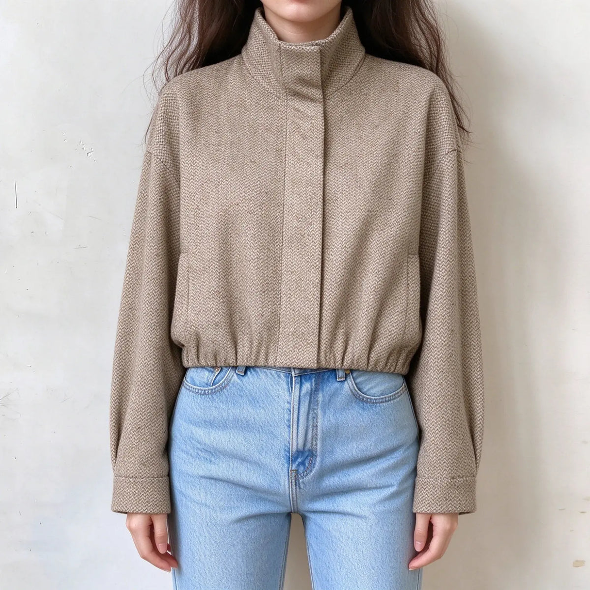 Model wearing herringbone stand collar cropped jacket with jeans, front view