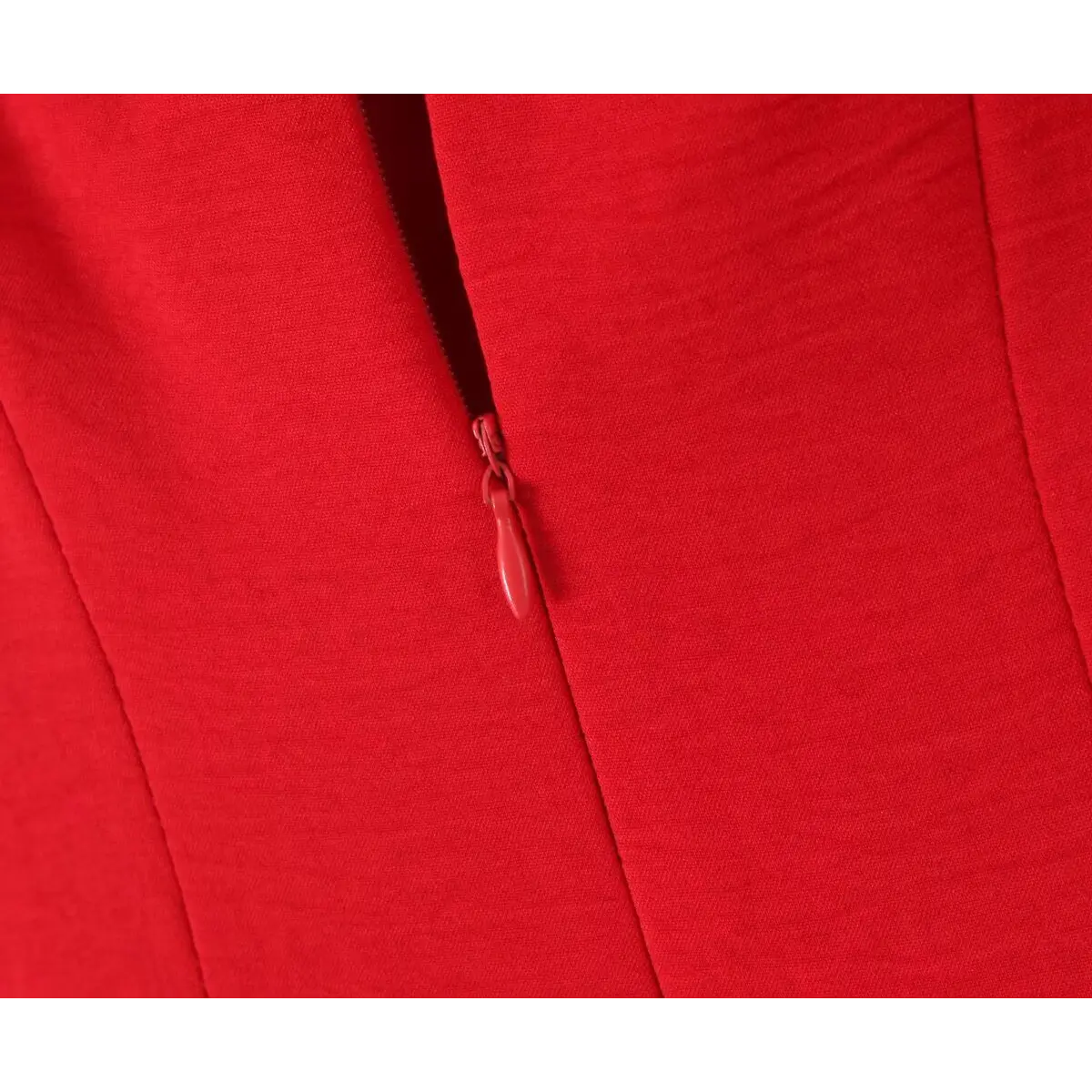 Close-up of the hidden back zipper on a red lace-trimmed cami dress, showing the fabric-covered pull and seamless stitching.