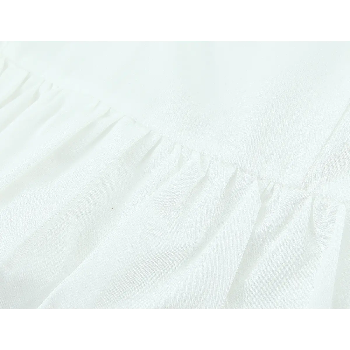 Close-up of the waist seam, showing the gathered fabric transition to the puffy hem
