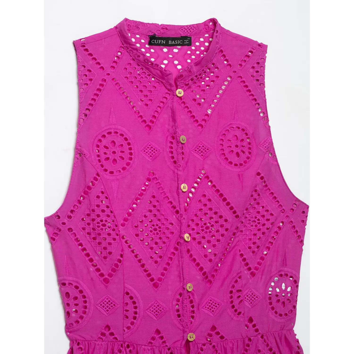 Full front wooden button placket and geometric eyelet embroidery close-up