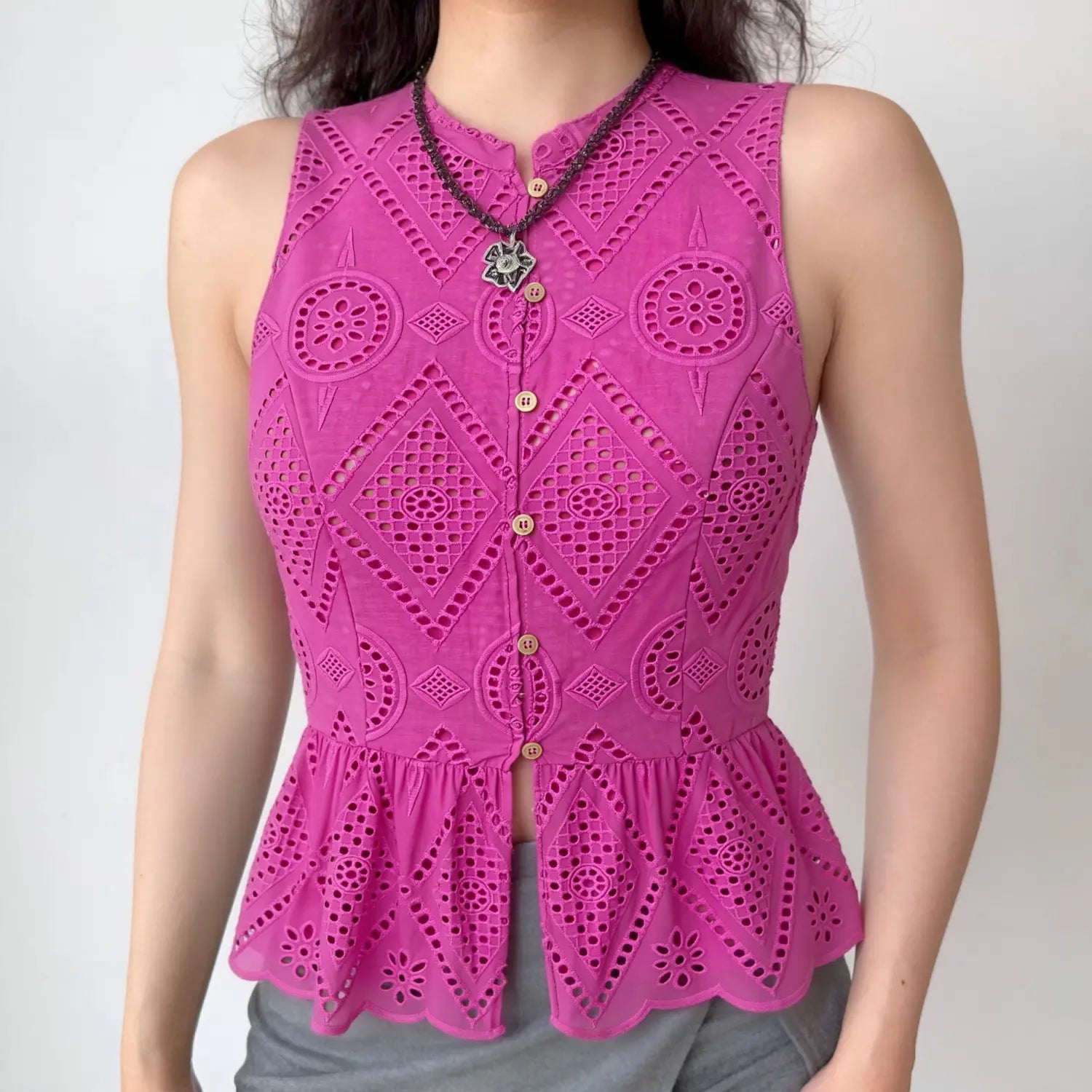  Model front view wearing hot pink eyelet sleeveless peplum top, casual everyday outfit