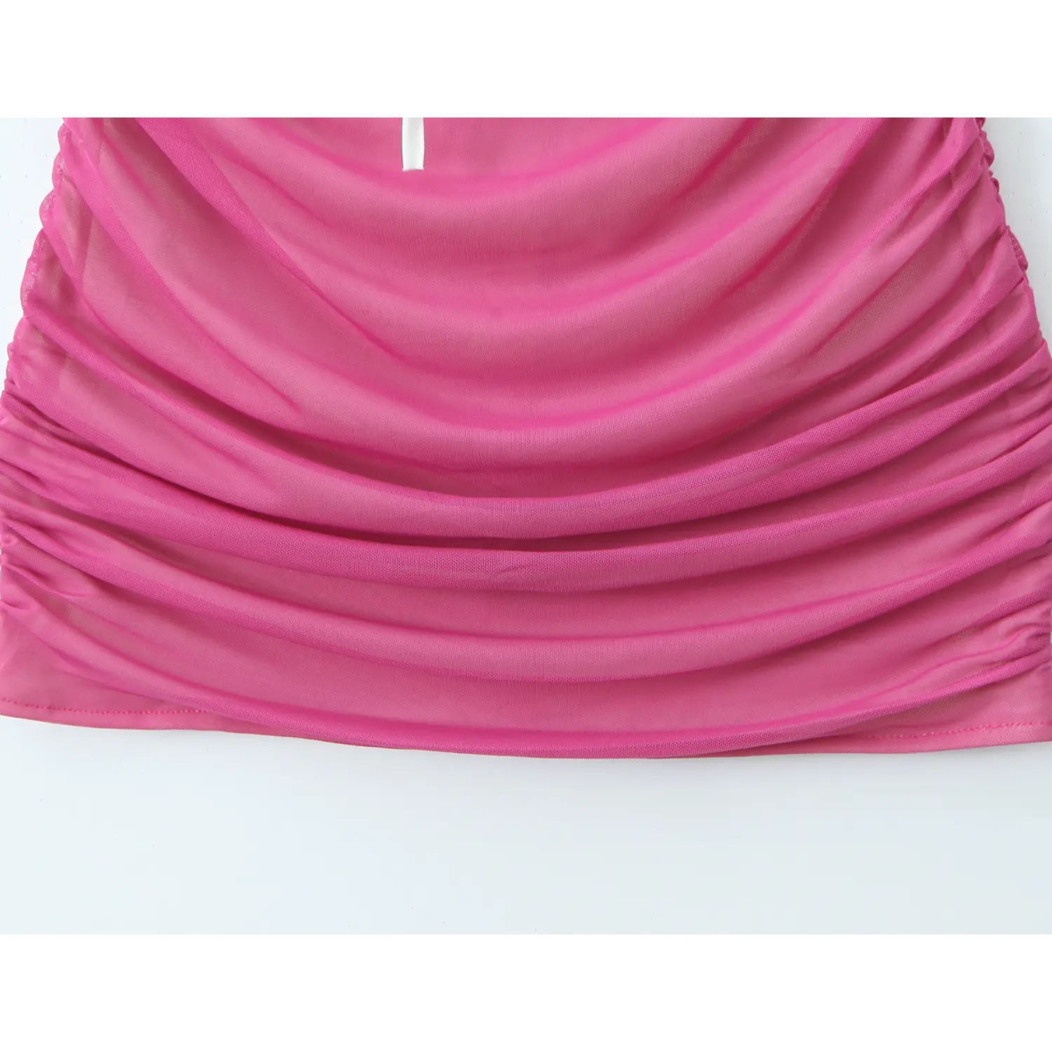 Macro close‑up of hot pink mesh fabric, heavy side ruched bodycon skirt texture detail