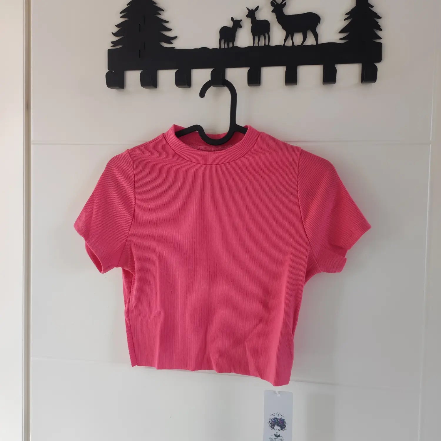 Hanger front view hot pink mock neck short sleeve vertical rib knit cropped top