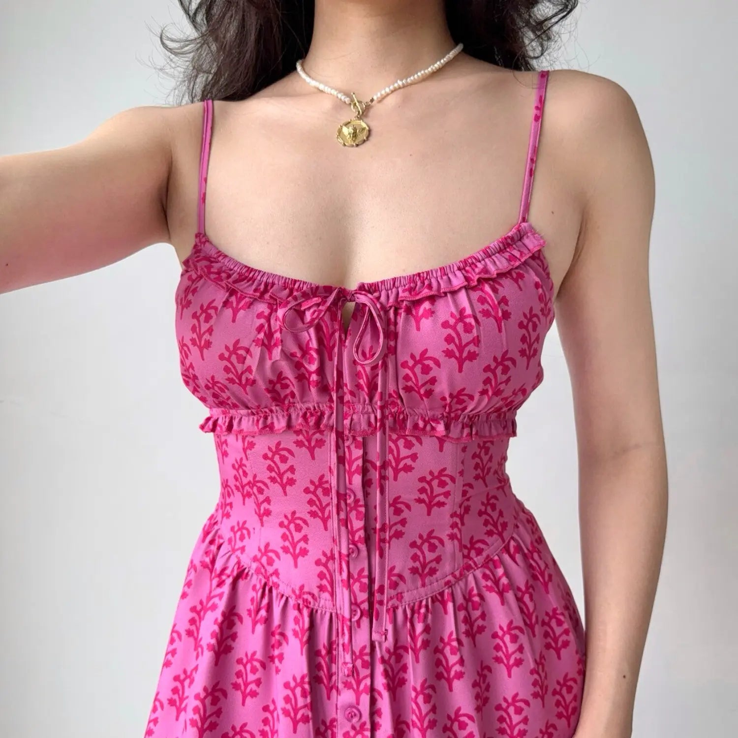 Close‑up shot bust and corset waist detail hot pink plant print cami dress tie front ruffle trim bodice