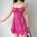 Model front spread hand pose hot pink plant print corset cami mini dress flowy ruffle hem casual sundress