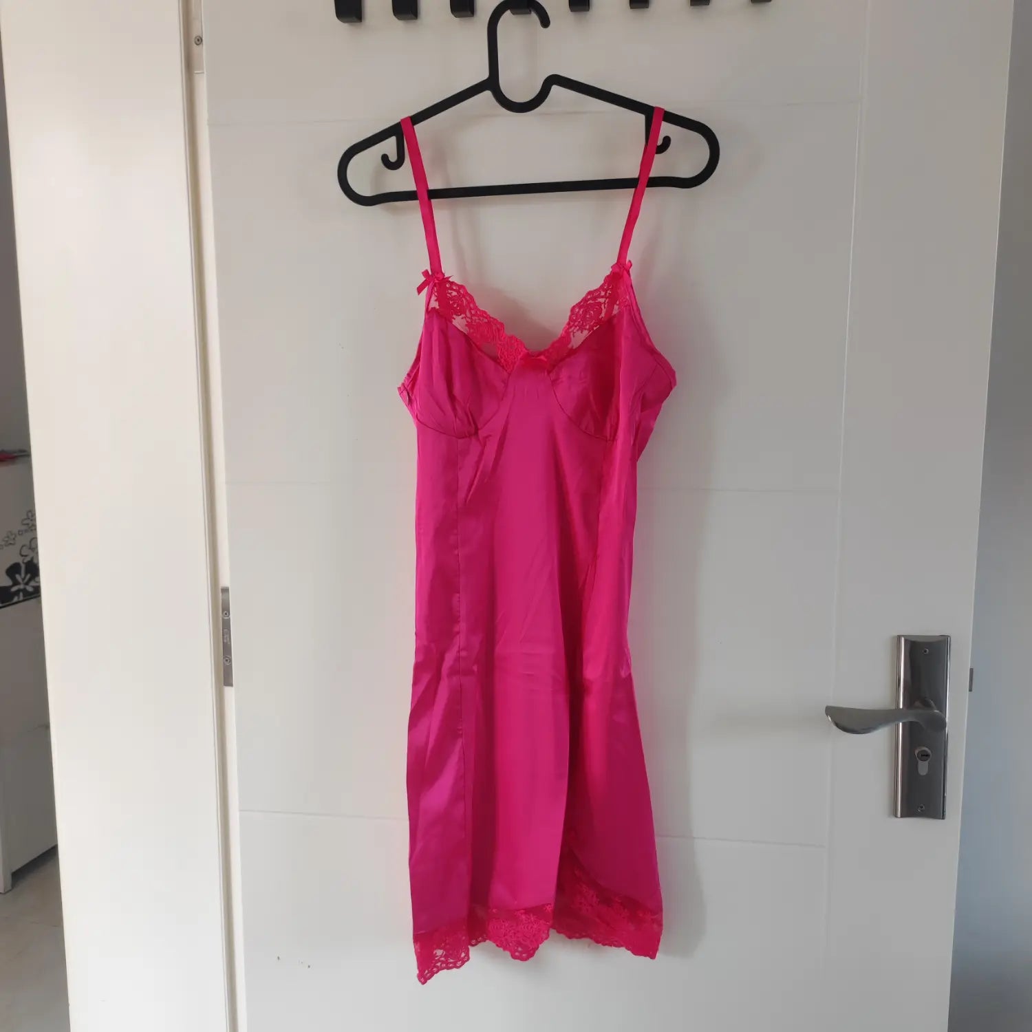 Front hanging shot hot pink satin slip mini dress with lace neckline and hem trim