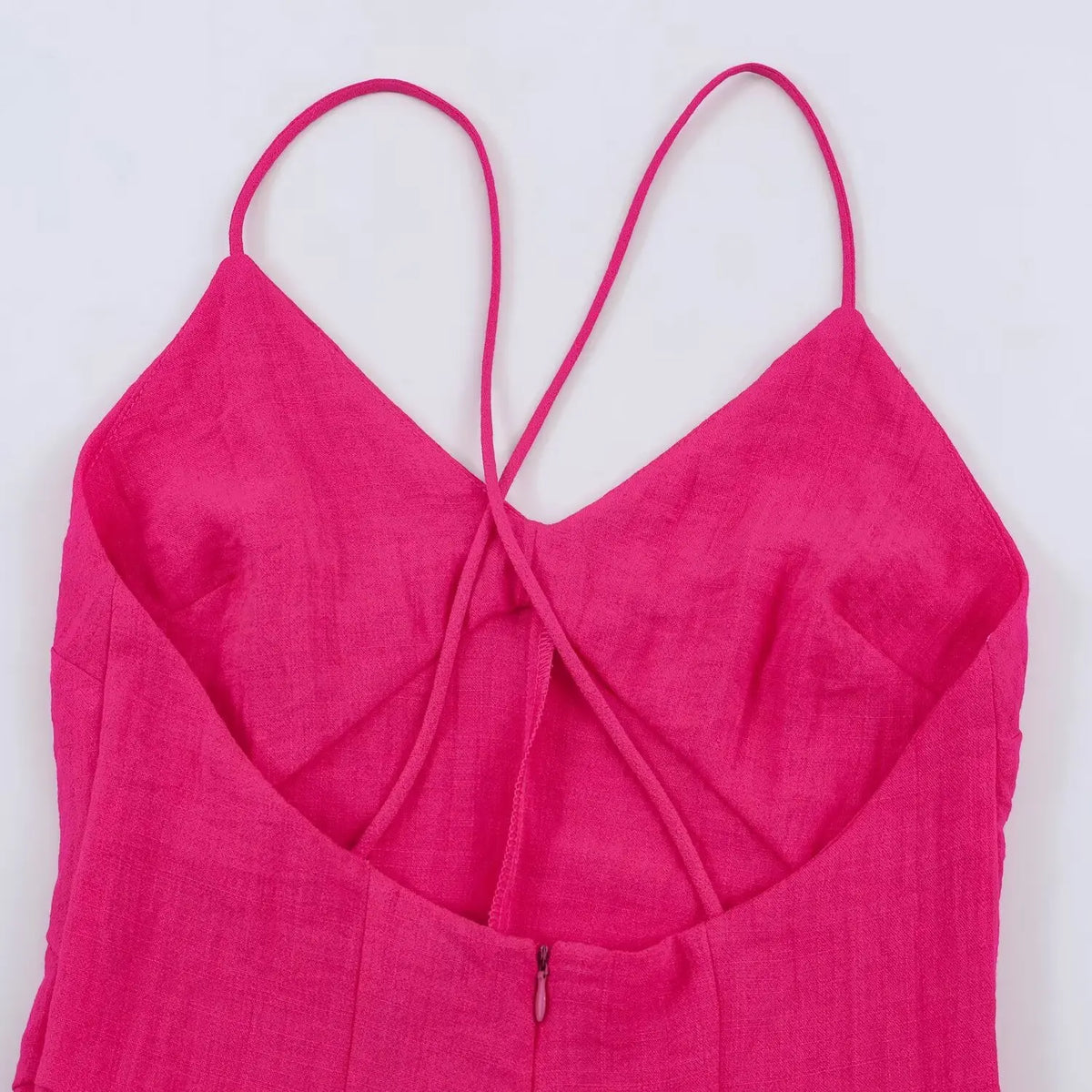 Close-up of crisscross back straps and centre back zip