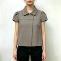 Model wearing houndstooth collared puff sleeve cropped blouse with black trousers