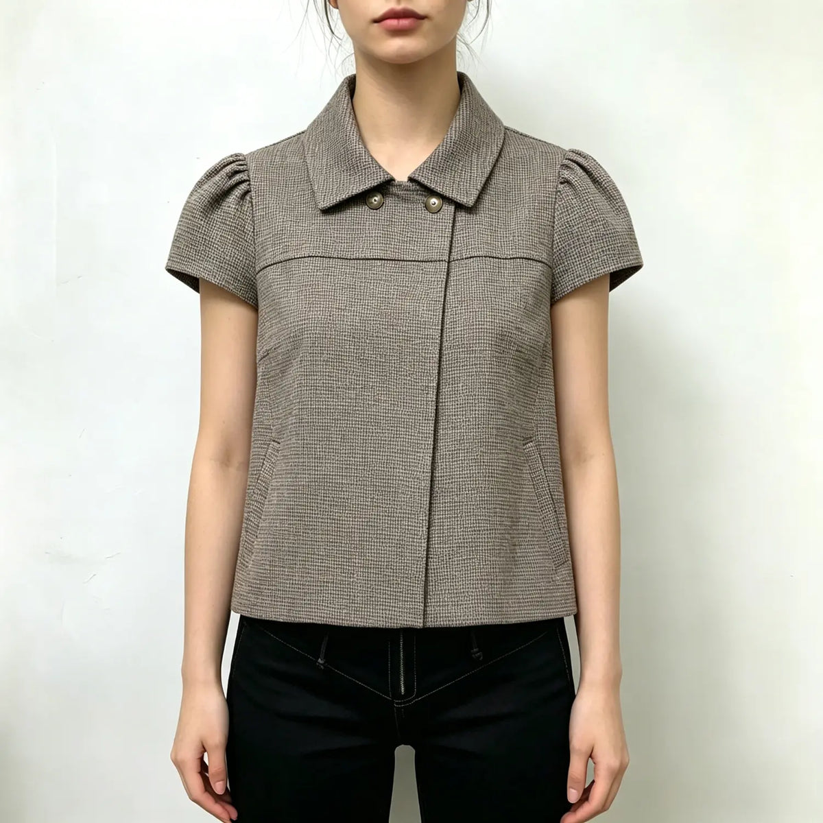 Model wearing houndstooth collared puff sleeve cropped blouse with black trousers