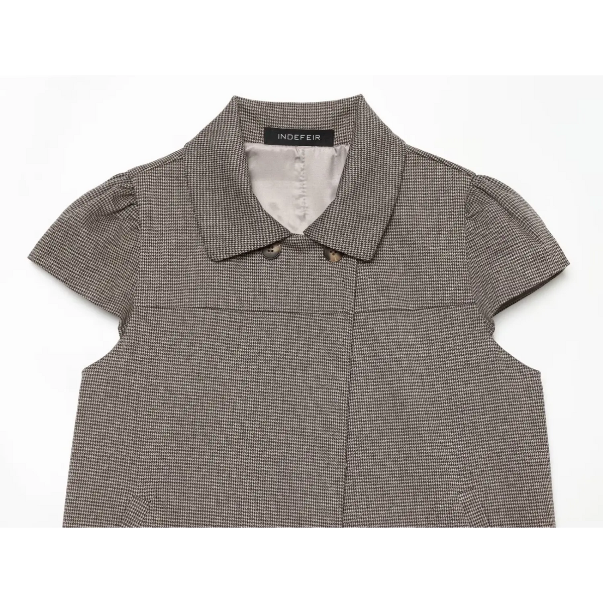Close-up of pointed collar asymmetrical placket and buttons
