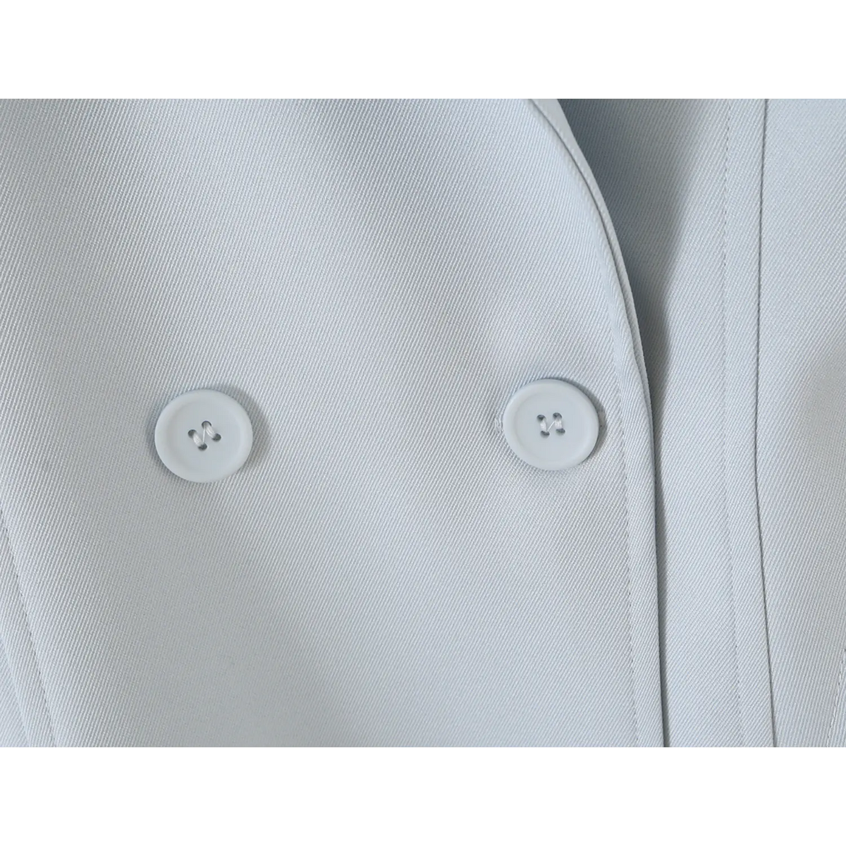 Close-up of double breasted matching buttons