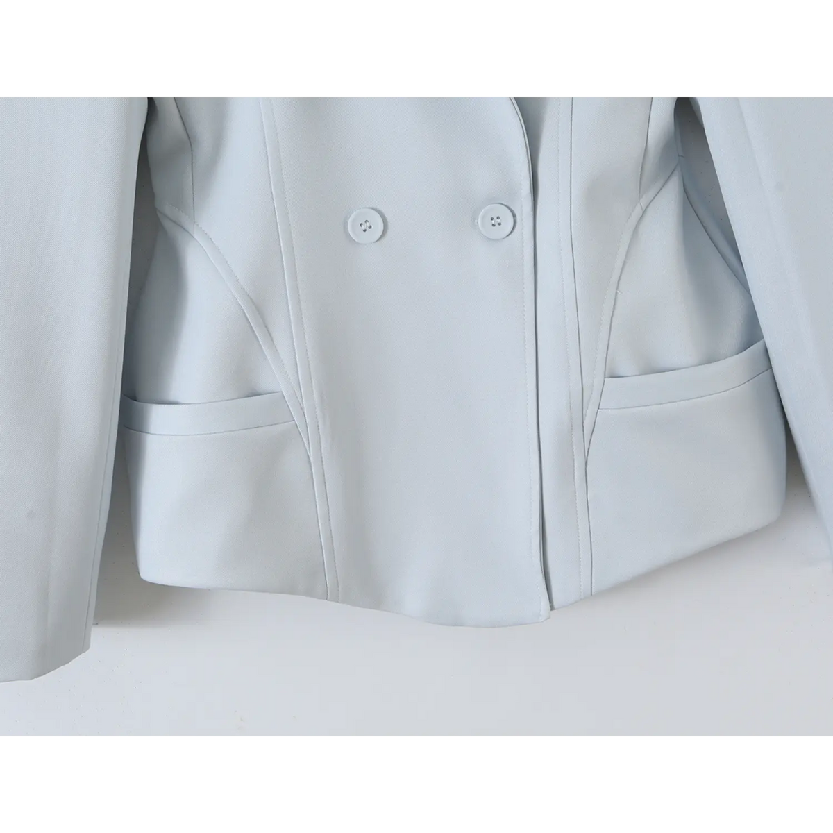 Close-up of curved hem and waist welt pockets