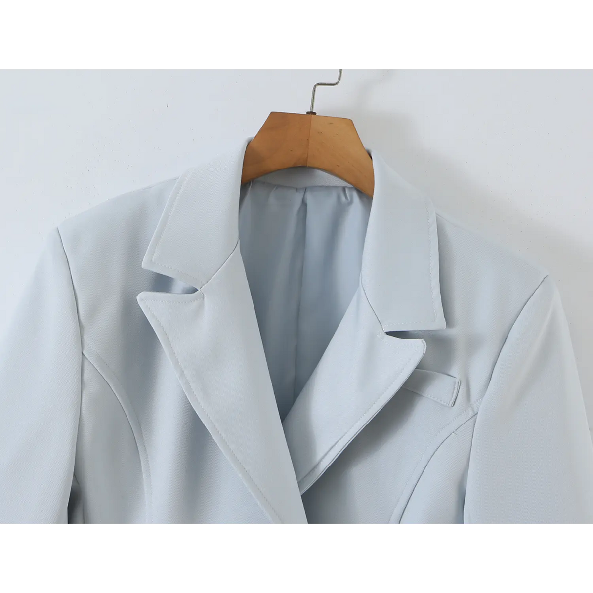 Close-up of notch lapel and shoulder on wooden hanger