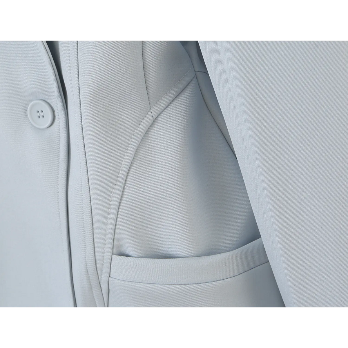 Close-up of waist welt pocket and matching button