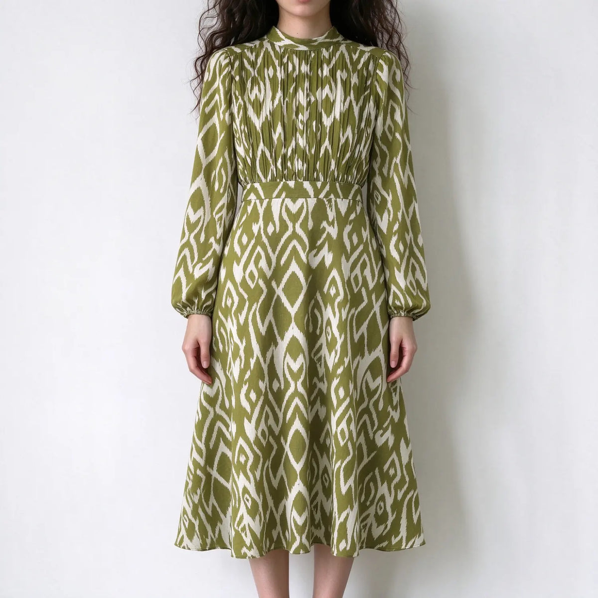 Model wearing ikat print pleated bodice high neck midi dress, front view