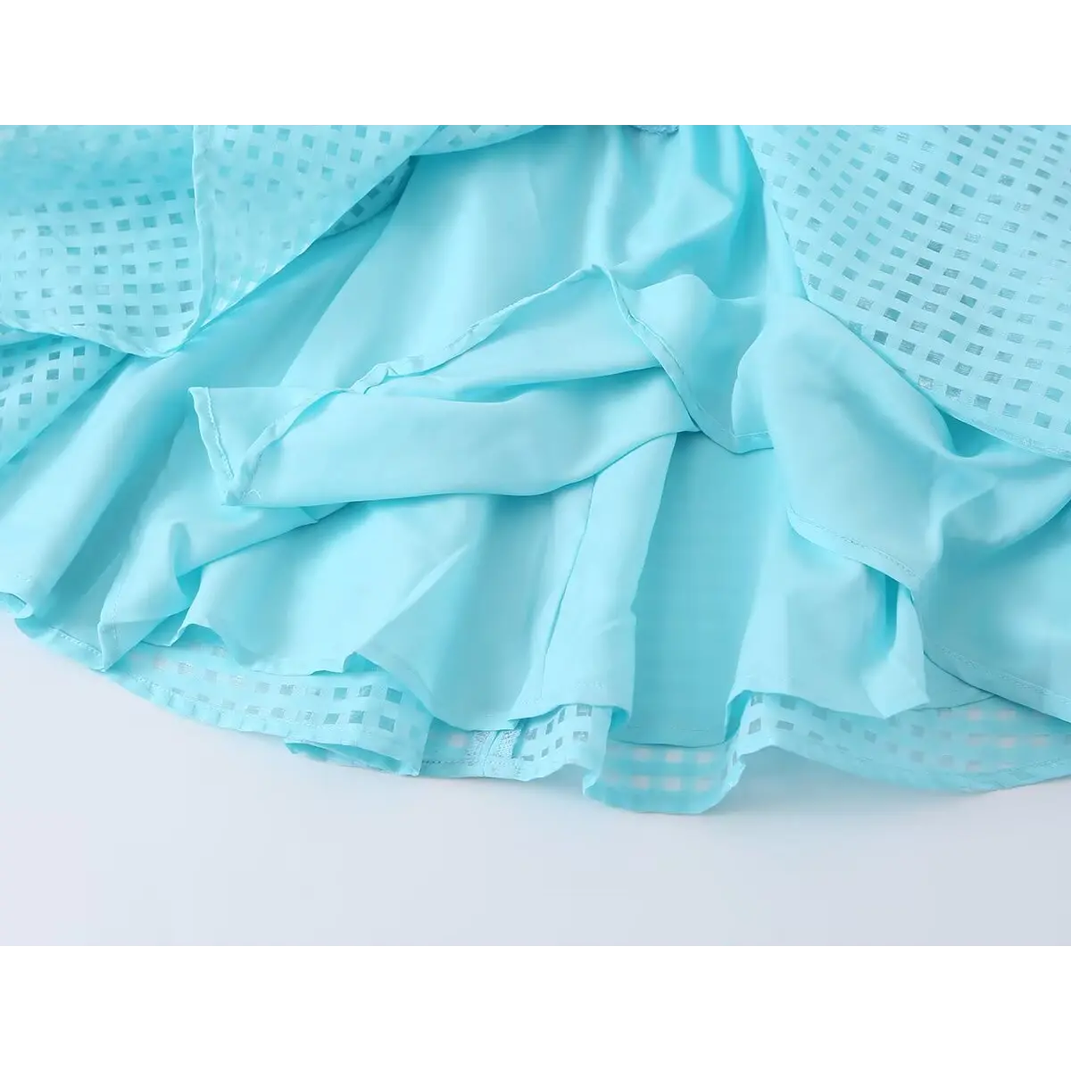 Inner full solid blue lining underneath semi-transparent jacquard skirt