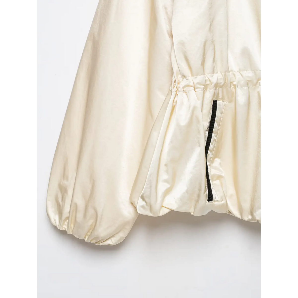 Close-up of gathered waist, pocket and bubble cuff