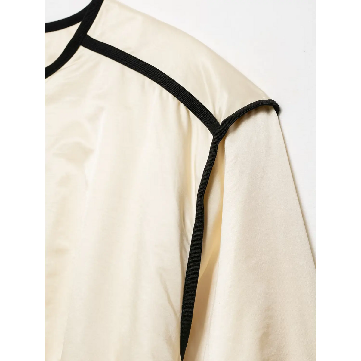 Close-up of shoulder piping seam detail