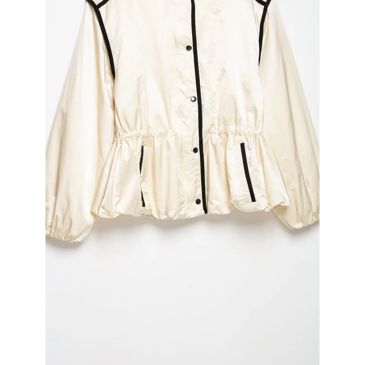 Close-up of gathered waist, pocket trim and bubble hem