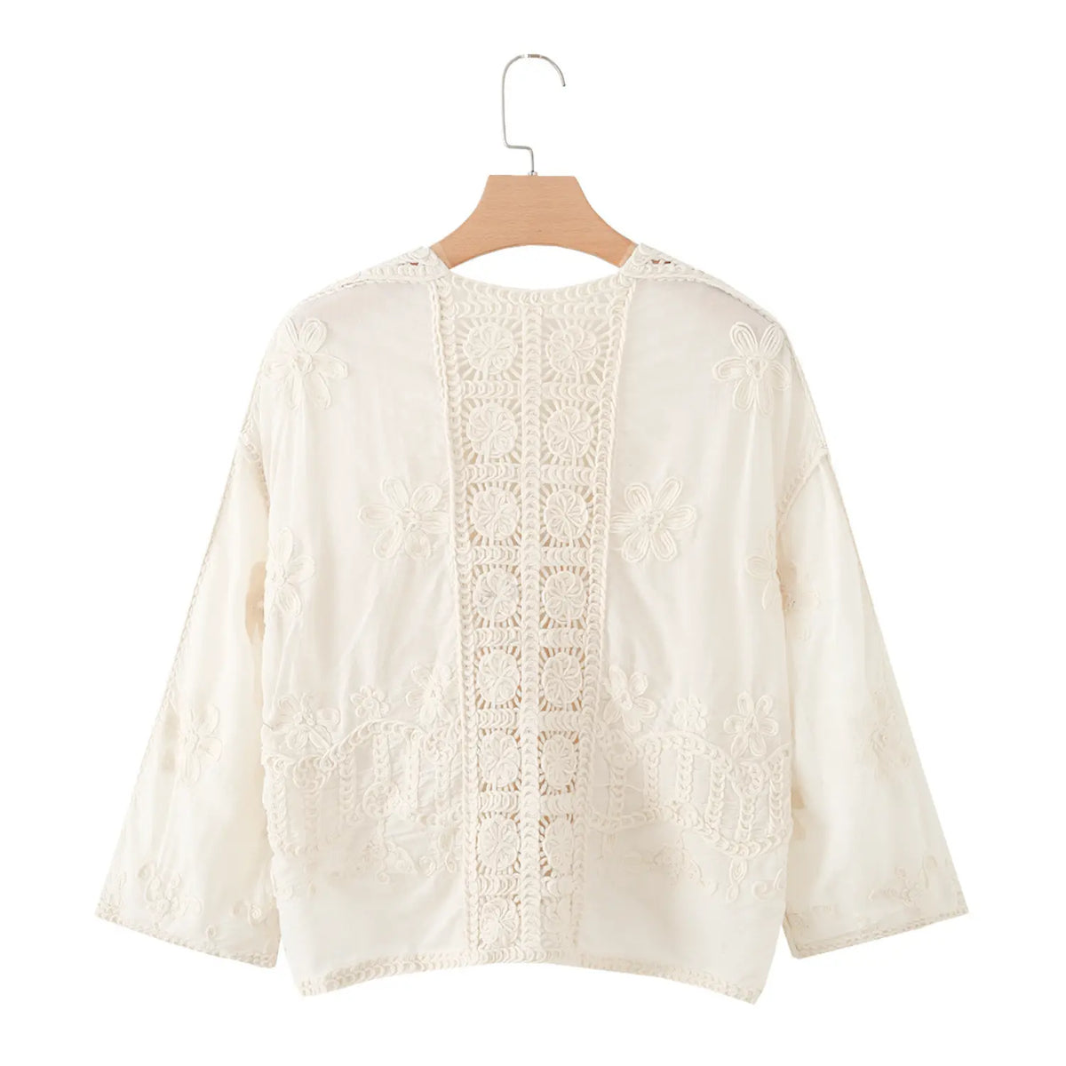 Back view of ivory cropped jacket with center back lace panel