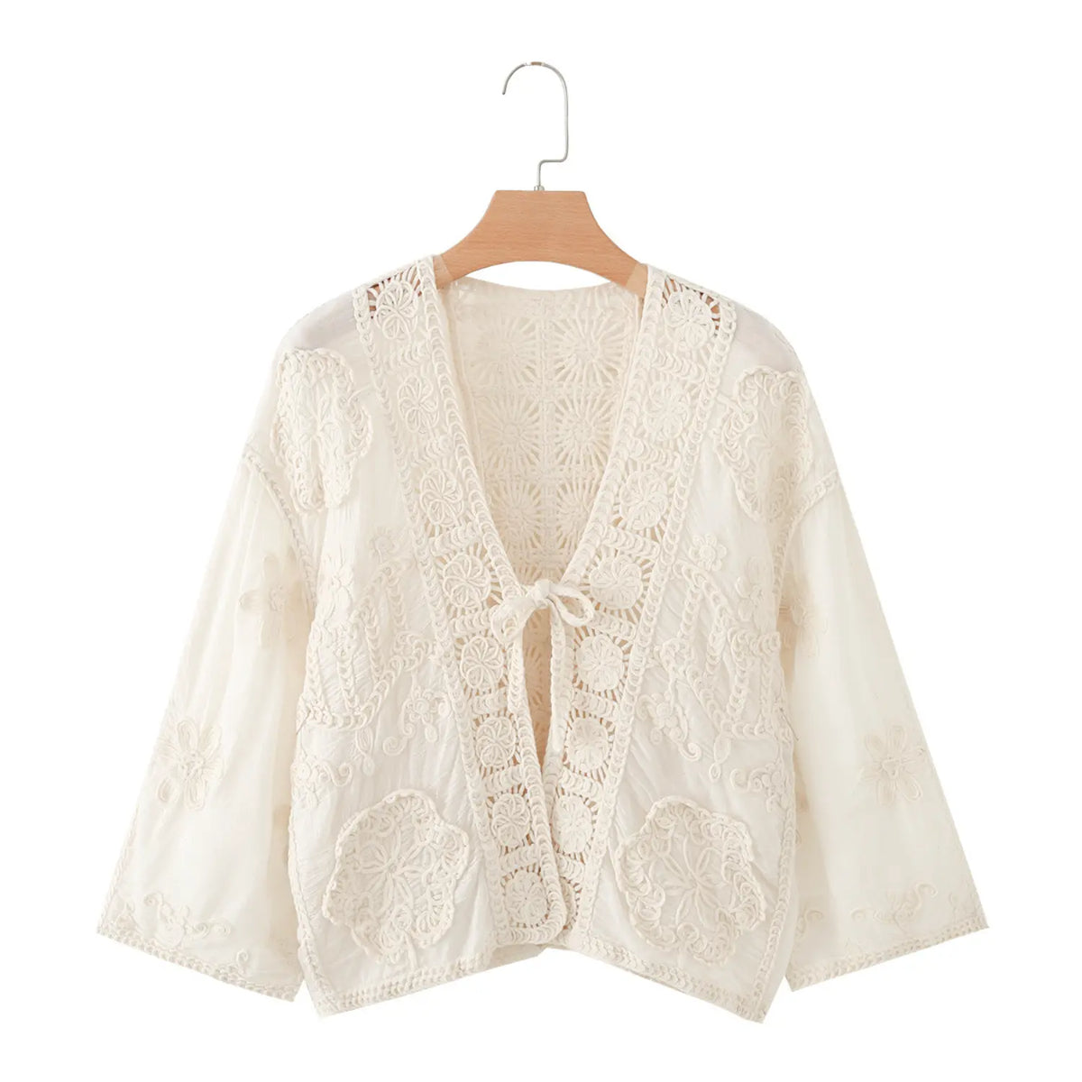 Front view of ivory crochet lace tie front cropped jacket on hanger