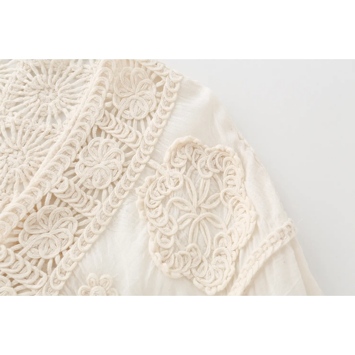 Close-up of shoulder crochet floral patch detail
