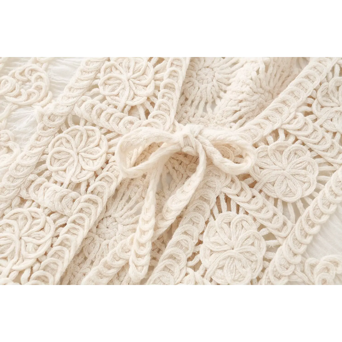 Close-up of center front tie bow on ivory jacket
