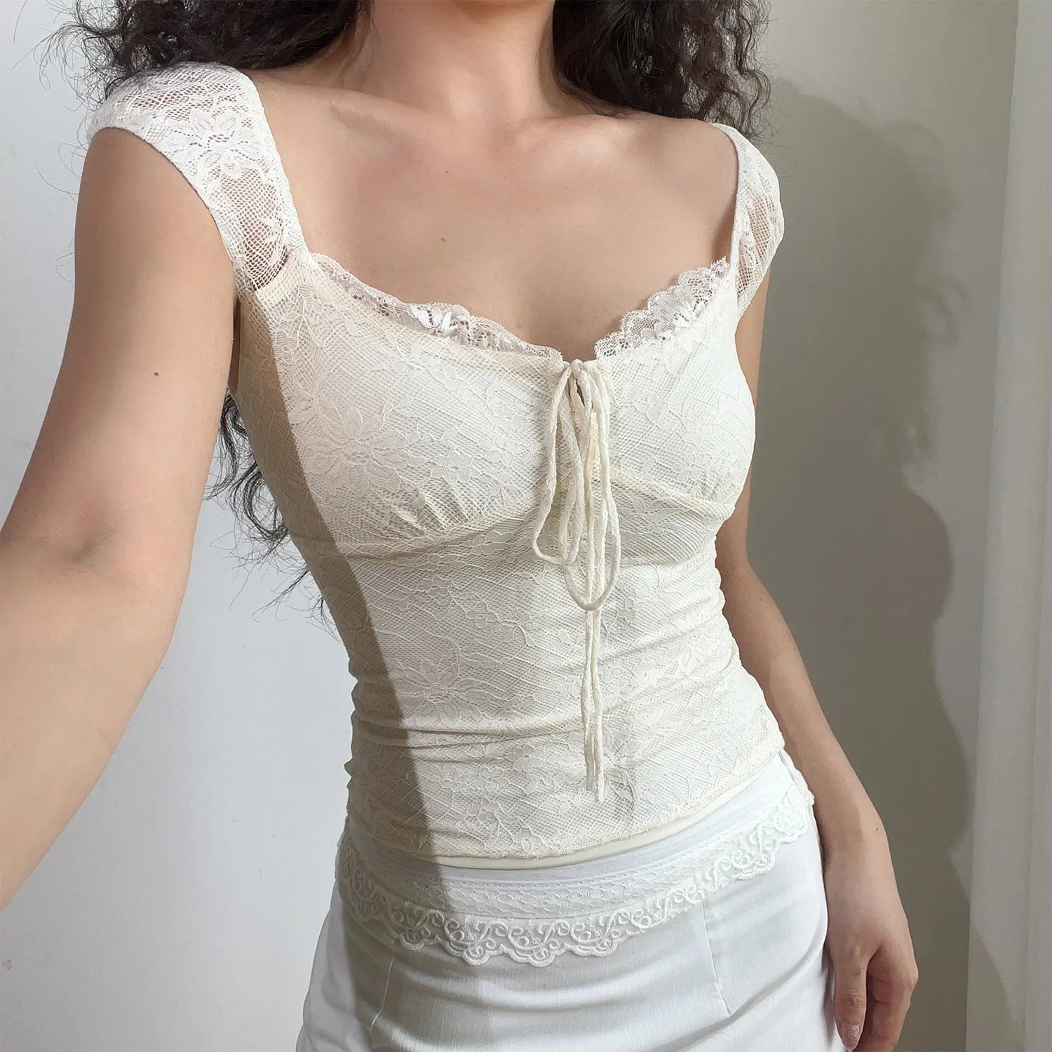 Ivory floral lace cropped cami front selfie shot, wavy lace square neck, front drawstring tie bow cap lace sleeves side waist ruched design match white skirt feminine daily outfit display