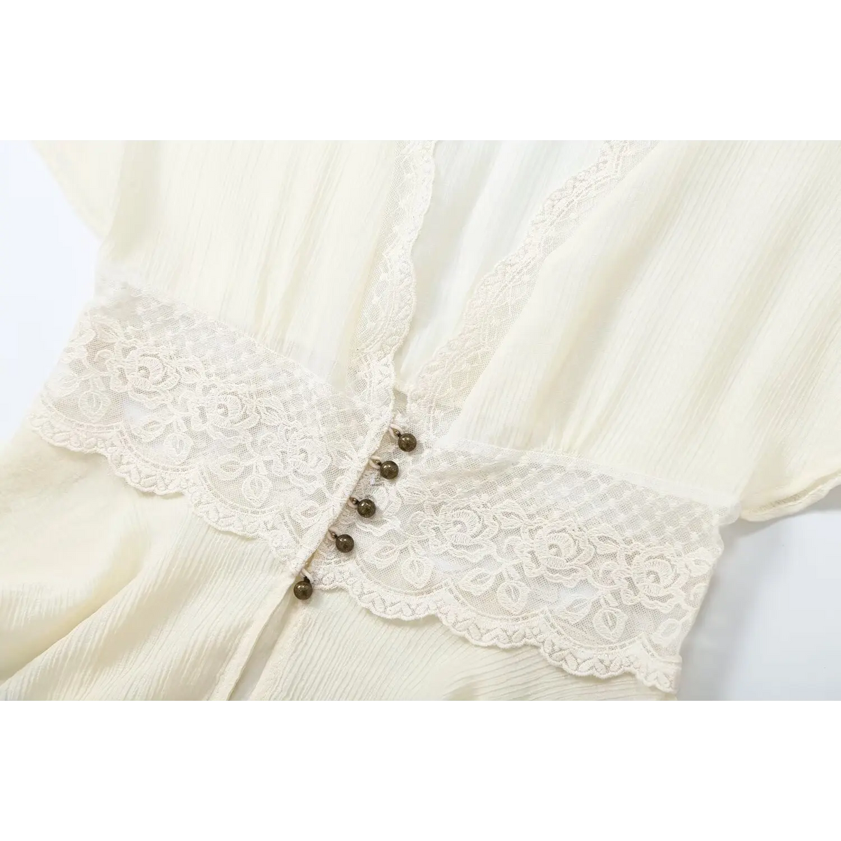 Close-up of waist lace panel and metal bead buttons