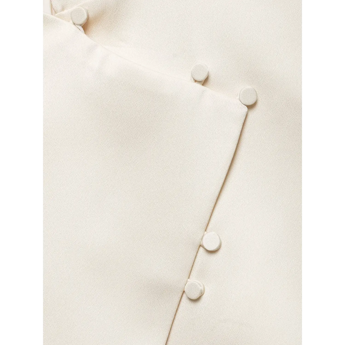 Close-up of covered buttons and wrap placket