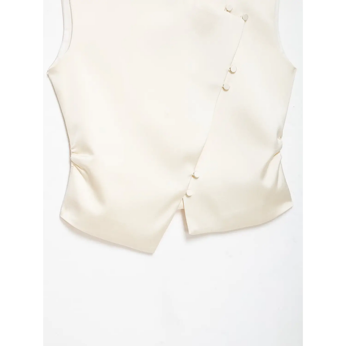 Close-up of cropped hem and button placket