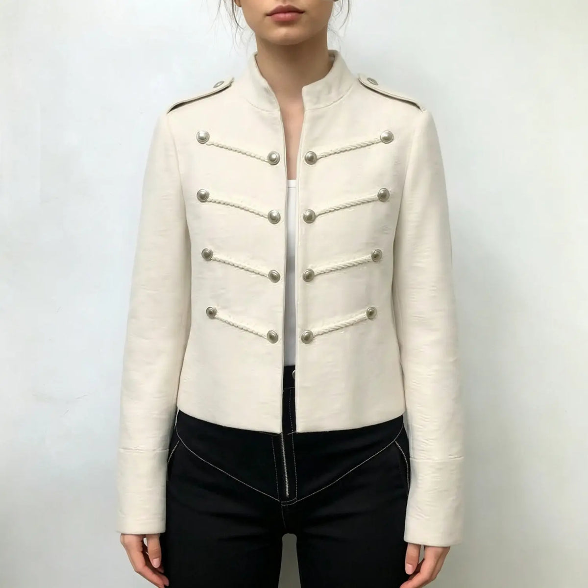 Model wearing ivory military cropped jacket with black trousers
