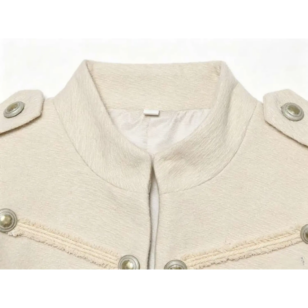 Close-up of stand collar and shoulder epaulette on ivory military jacket