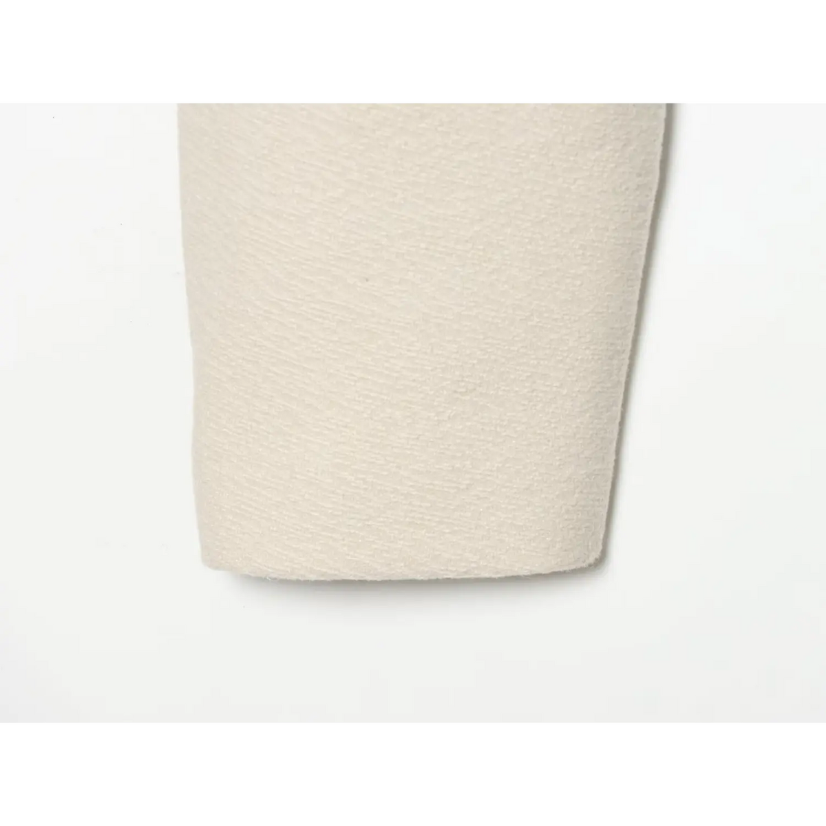 Close-up of textured sleeve fabric on ivory military jacket