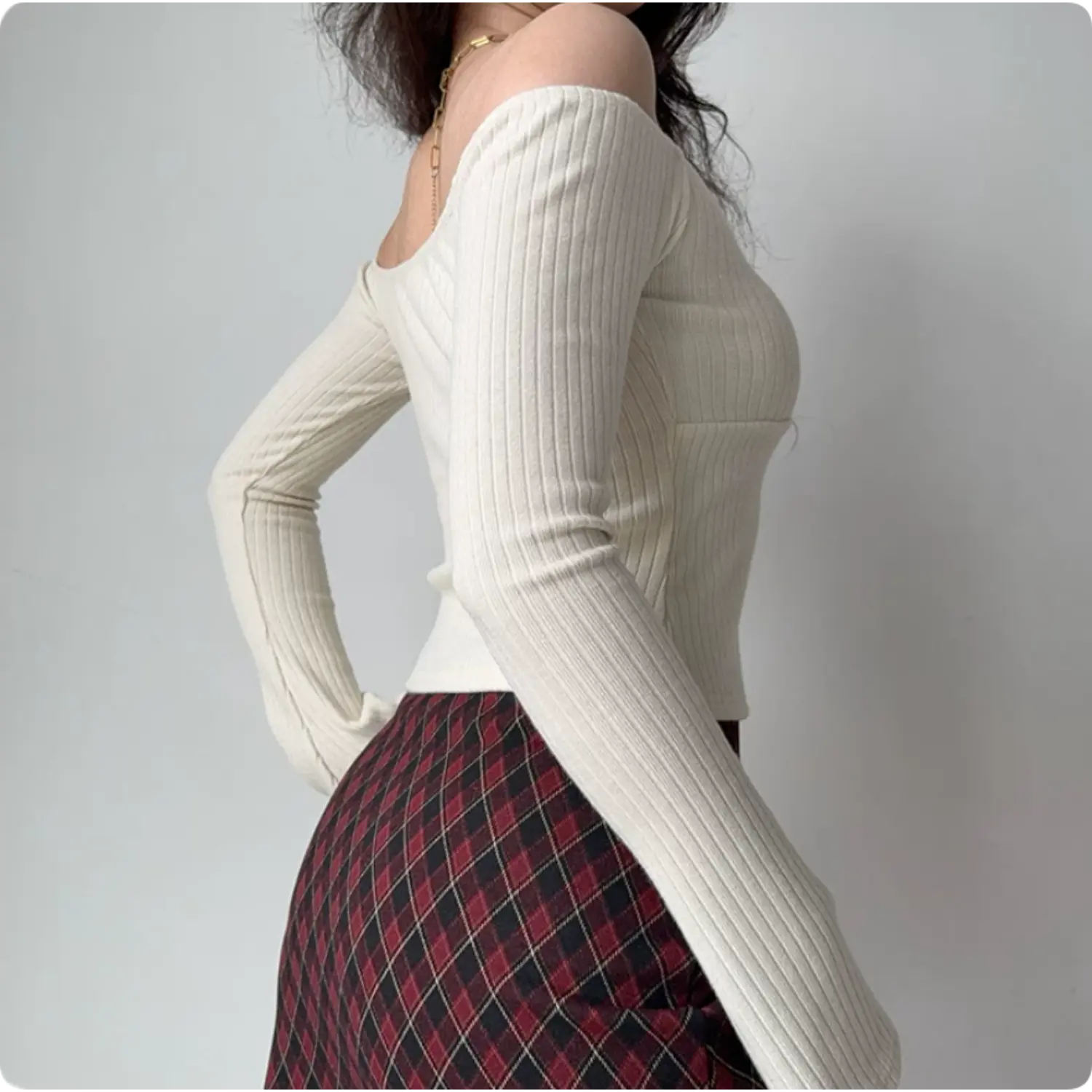 Side back shot of ivory ribbed off shoulder fitted top, flare long sleeve stretch slim cropped women casual tee