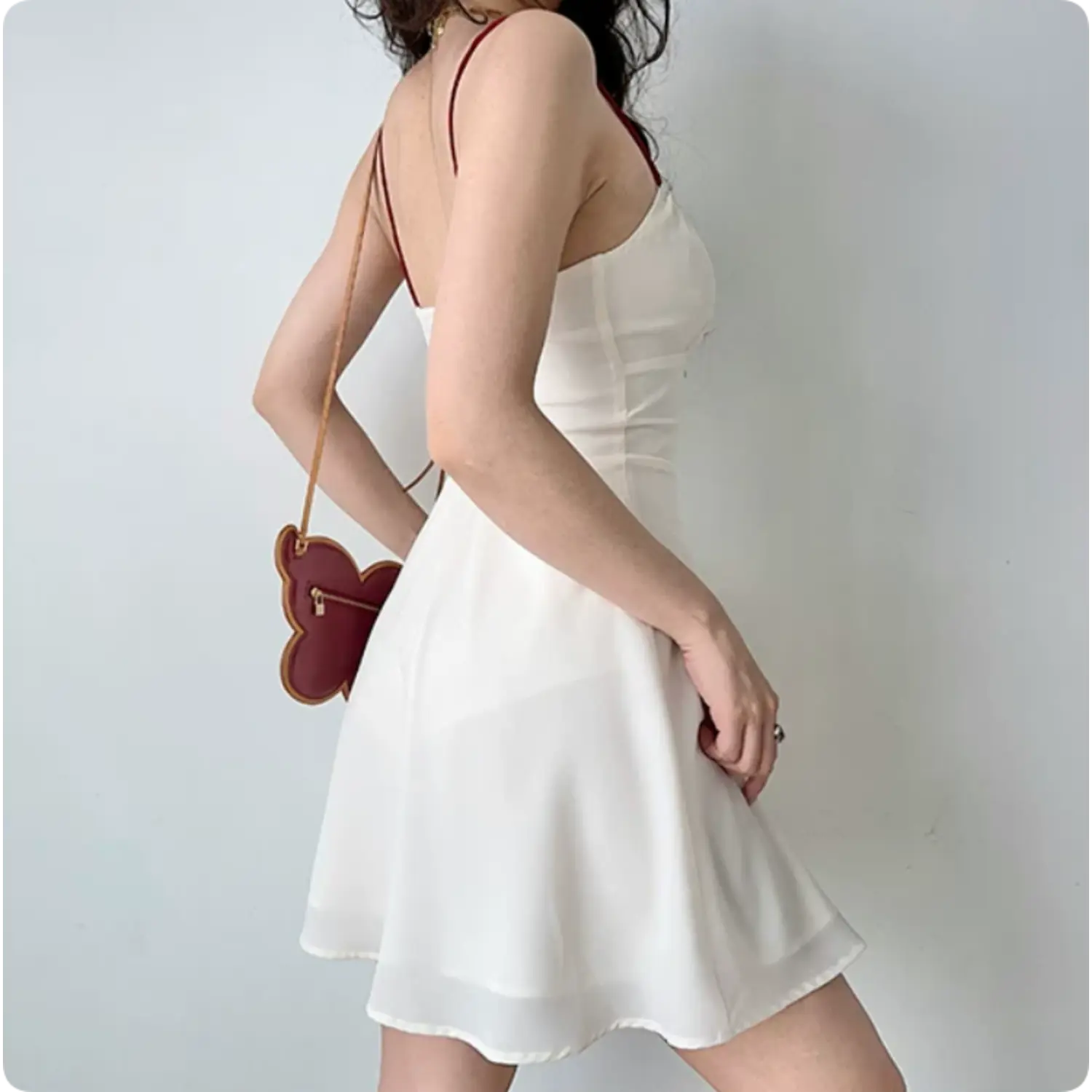 Side back shot ivory silky cami mini dress, thin red contrast straps, low open back, flowy A-line short skirt