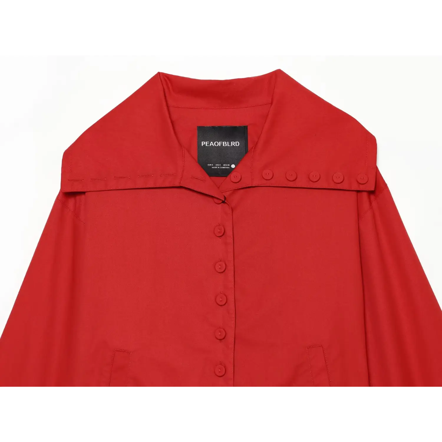 Jacket inner collar label macro close-up, woven brand tag row of decorative neck buttons neat binding stiff utility fabric neck sewing detail shot